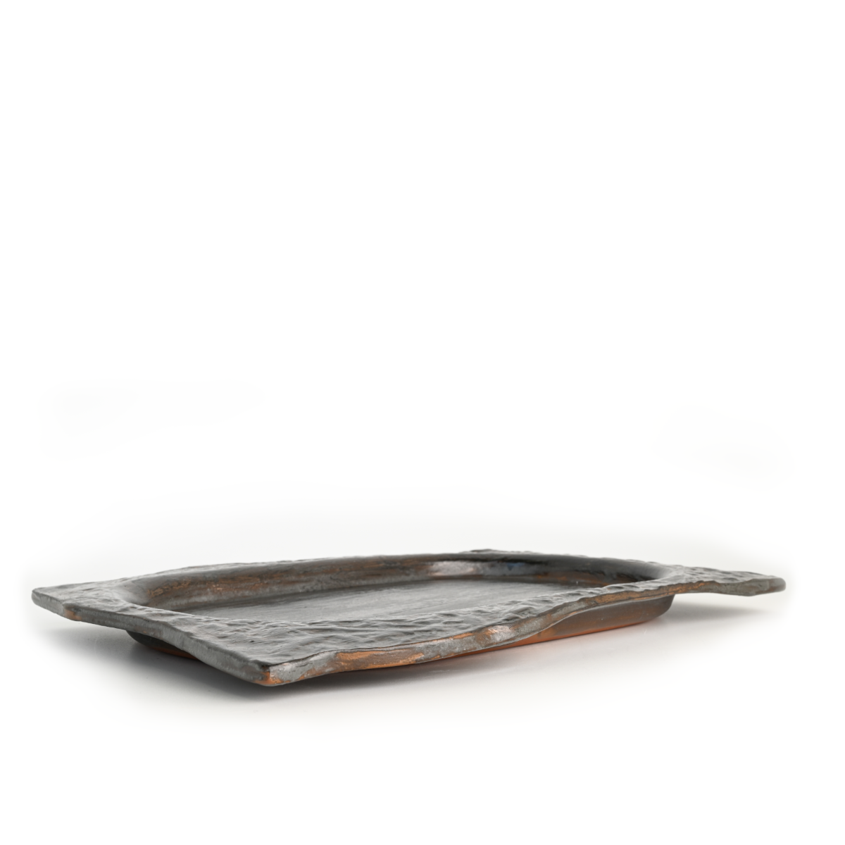Side view of the Chiseled Serving Platter showing rough chiseled edges and smooth plating surface