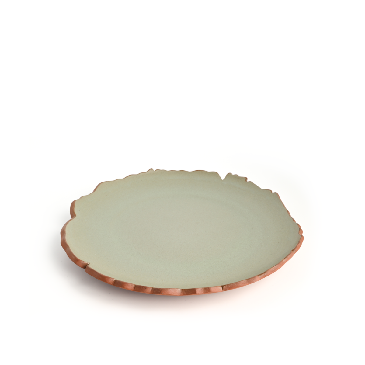 Top view of the Coupe Cut-Edge Dinner Plate showing its irregular cut edges and green glaze