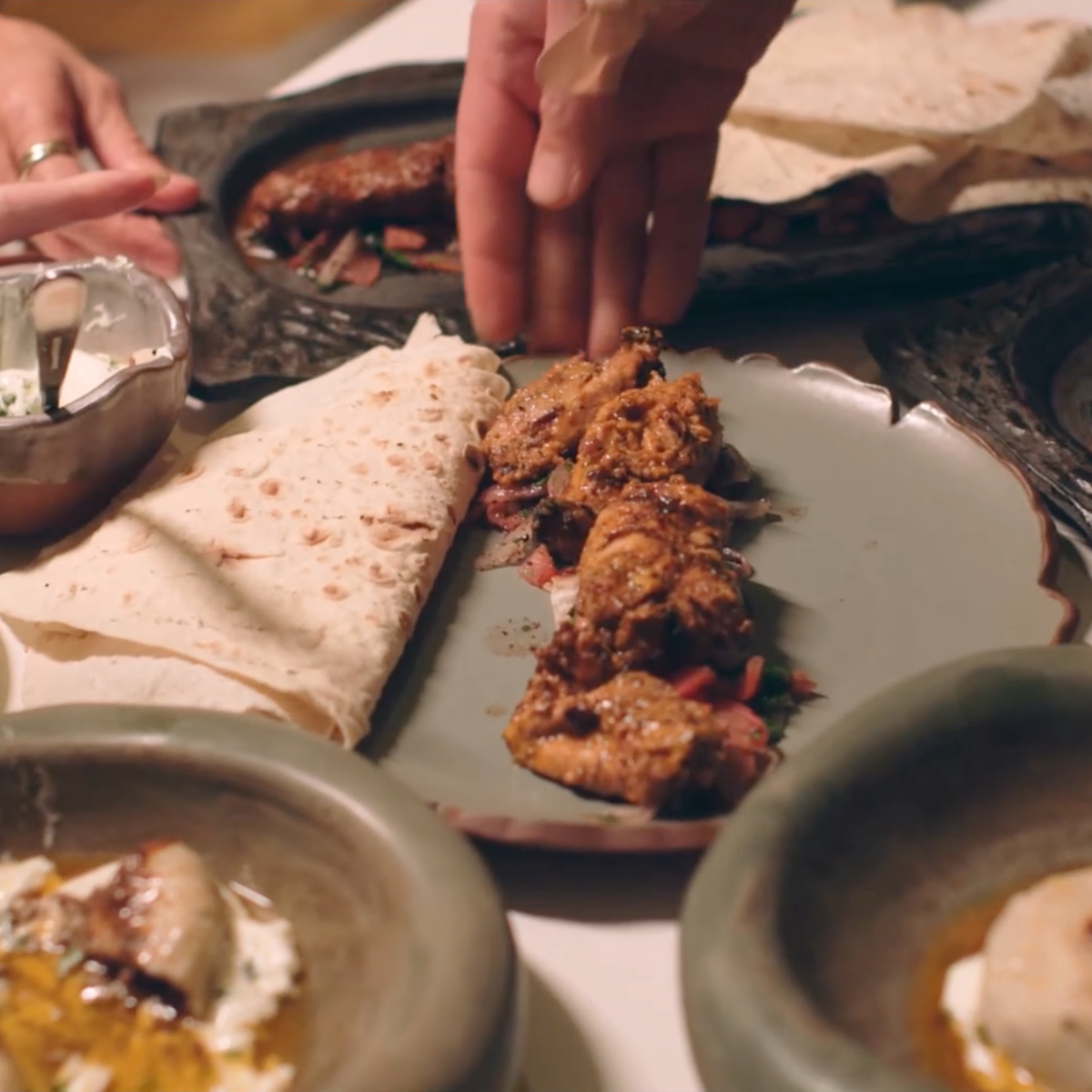 Chef plating the Coupe Cut-Edge Dinner Plate during service